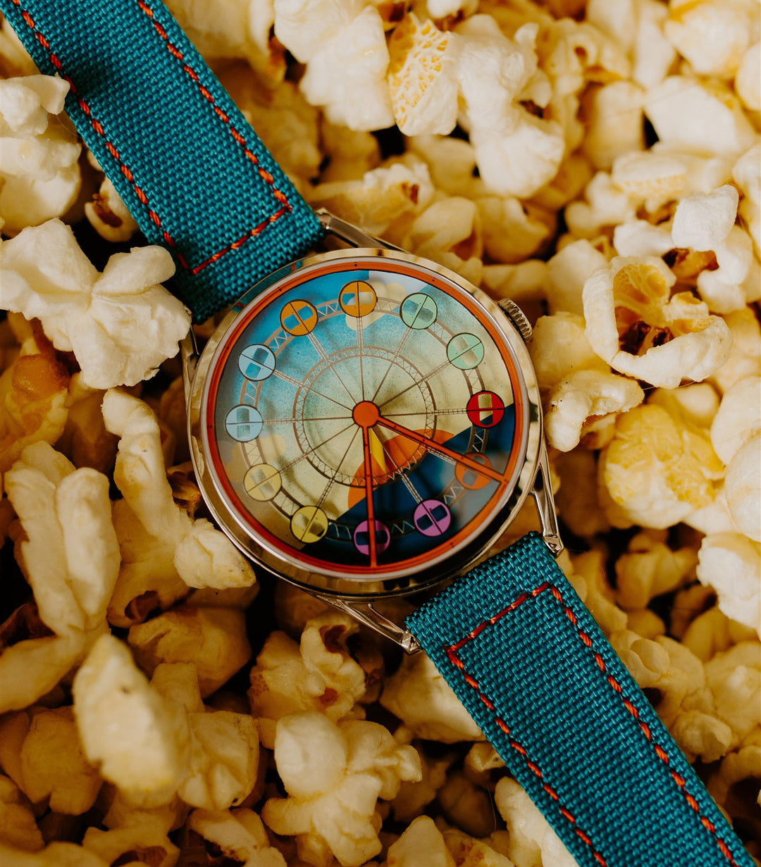 Enjoy the ride watch on popcorn background