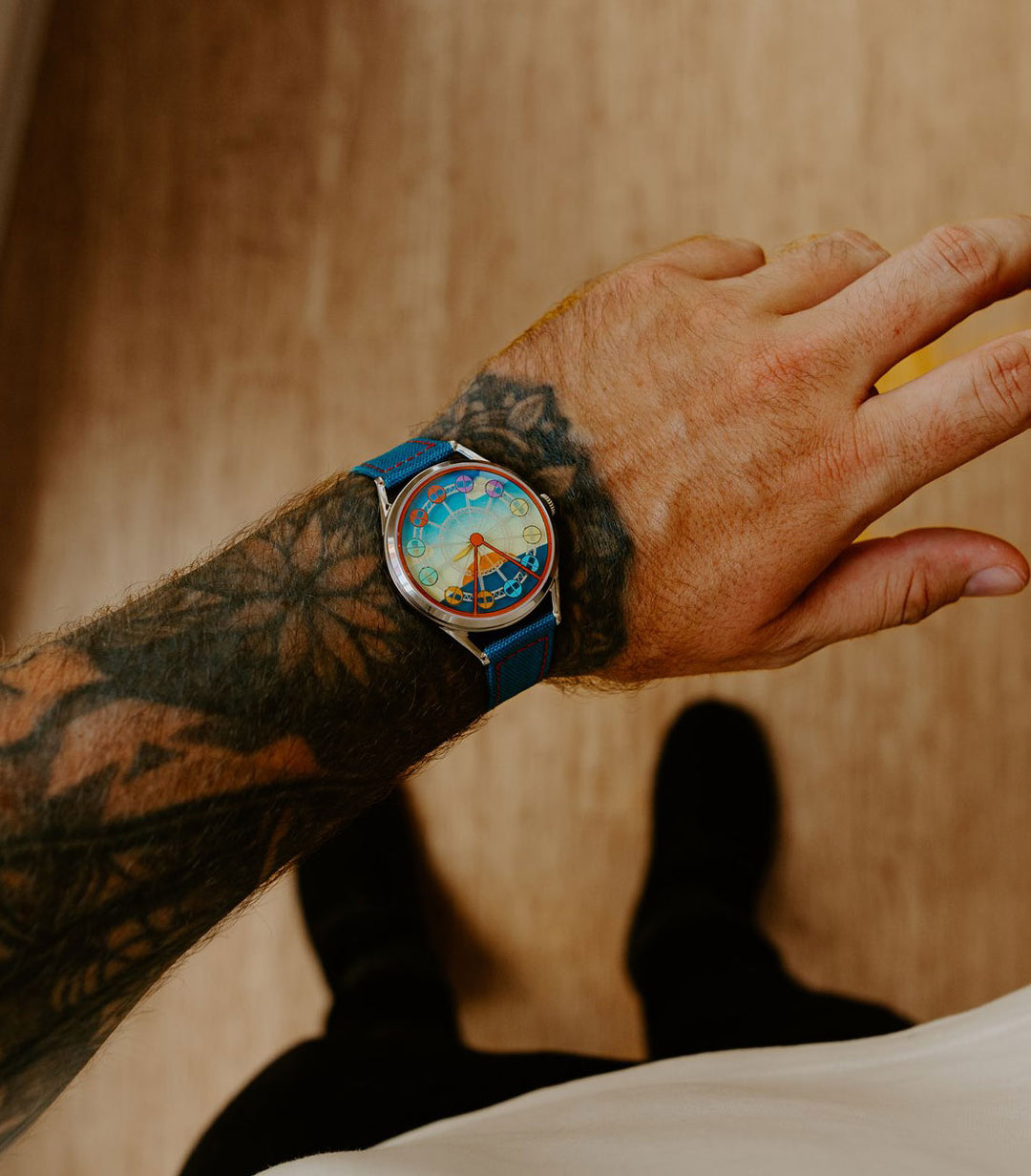 Enjoy the ride watch on tattooed wrist